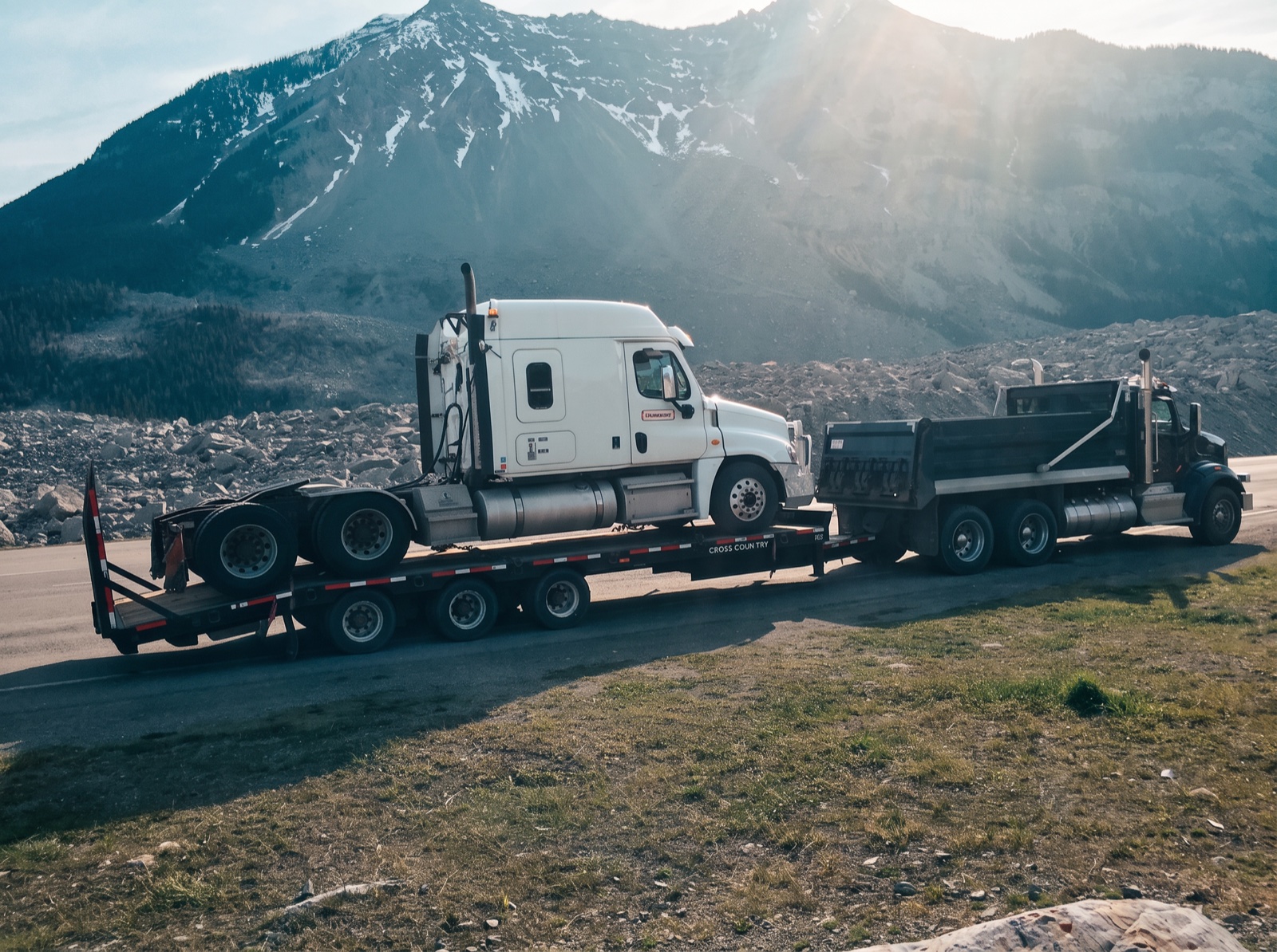 Highway tractor hauled on a step deck through the Rockies